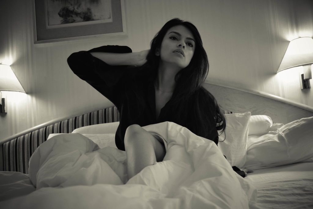 black shirt in bed fashion shoot